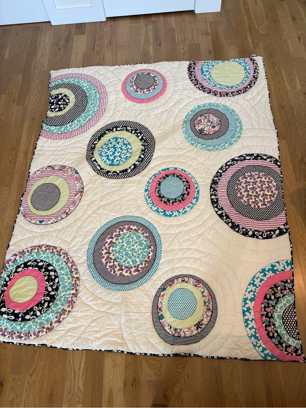 Cream Quilted Circle-Pattern Bedspread with Pink and Teal Accents